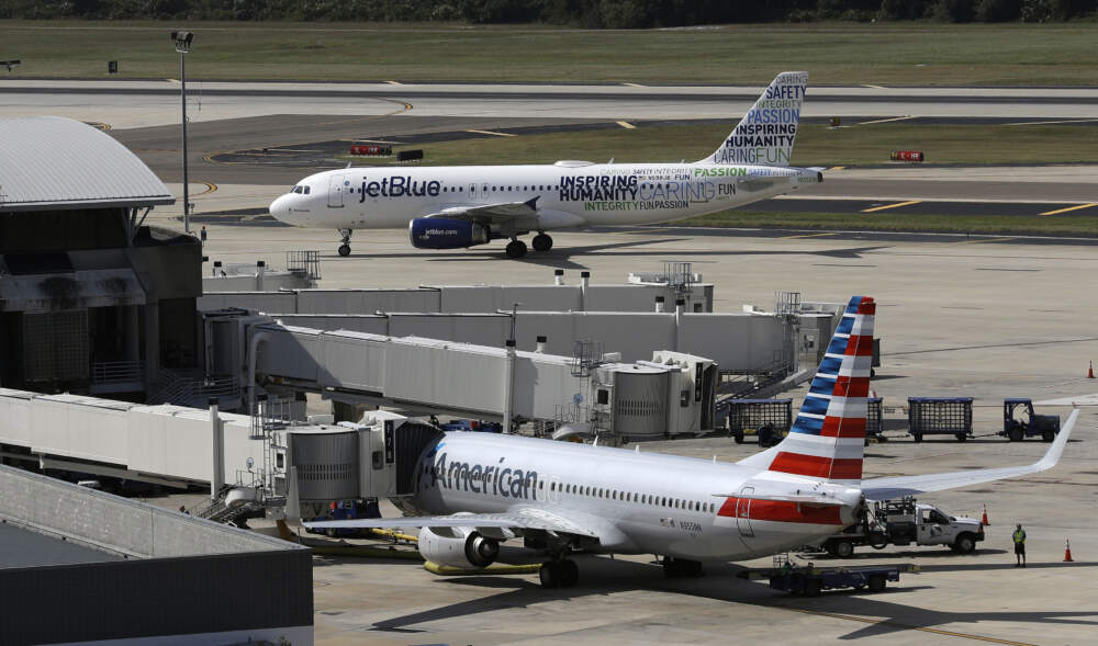 A JetBlue Airbus A320 taxis to a gate after landing, Oct. 26, 2016, as an American Airlines jet is seen parked at its gate at Tampa International Airport in Tampa, Fla. JetBlue on Wednesday, July 5, 2023, said it won't appeal a judge's ruling against its partnership with American Airlines, effectively dropping the deal in an effort to salvage its purchase of Spirit Airlines. (Chris O'Meara/AP)