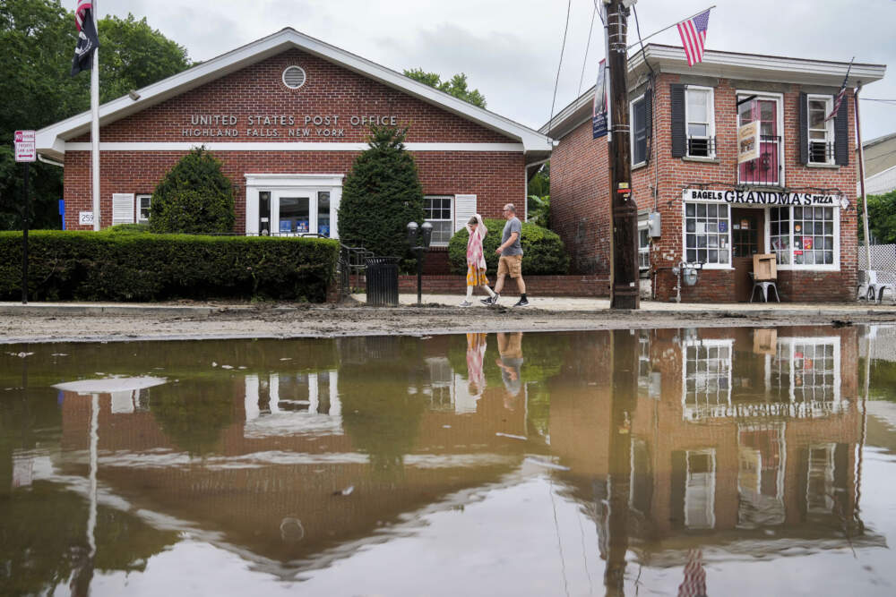 Pedestrians pass along Main Street that was damaged by flooding the previous day, July 10, 2023, in Highland Falls, N.Y.(John Minchillo/AP)