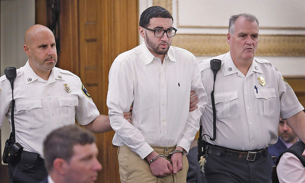 Emanuel Lopes, center, is escorted into court on day one of his trial at Norfolk Superior Court, in Dedham, Mass., on June 8, 2023. (Greg Derr/The Patriot Ledger via AP)