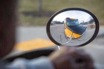 Henry Birkemose drives an electric school bus through Beverly, Mass. (Robin Lubbock/WBUR)