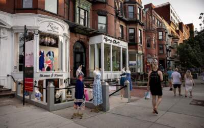 Pedestrians glance at store mannequins on Newbury Street in Boston's Back Bay. (Robin Lubbock/WBUR)