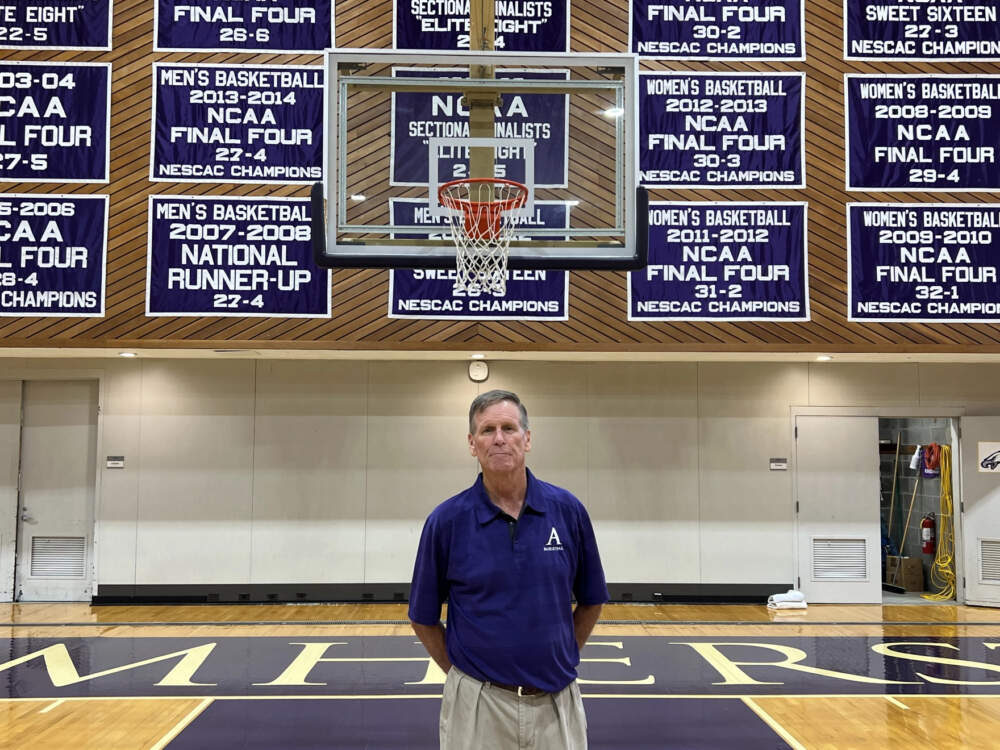 Dave Hixon, the retired men's basketball coach at Amherst College, poses at LeFrak Gymnasium on the school's campus. (Adam Frenier/NEPM)