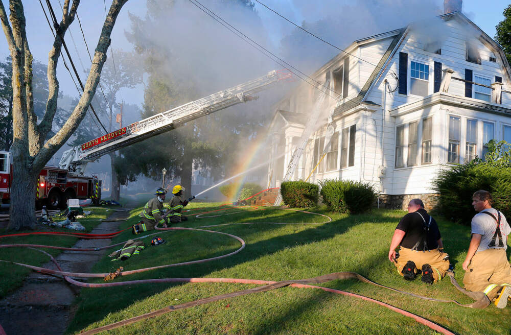 FILE - Firefighters battle a house fire on Herrick Road, Sept. 13, 2018, in North Andover, Mass., one of multiple emergency crews responding to a series of gas explosions and fires triggered by a problem with a gas line that feeds homes in several communities north of Boston.