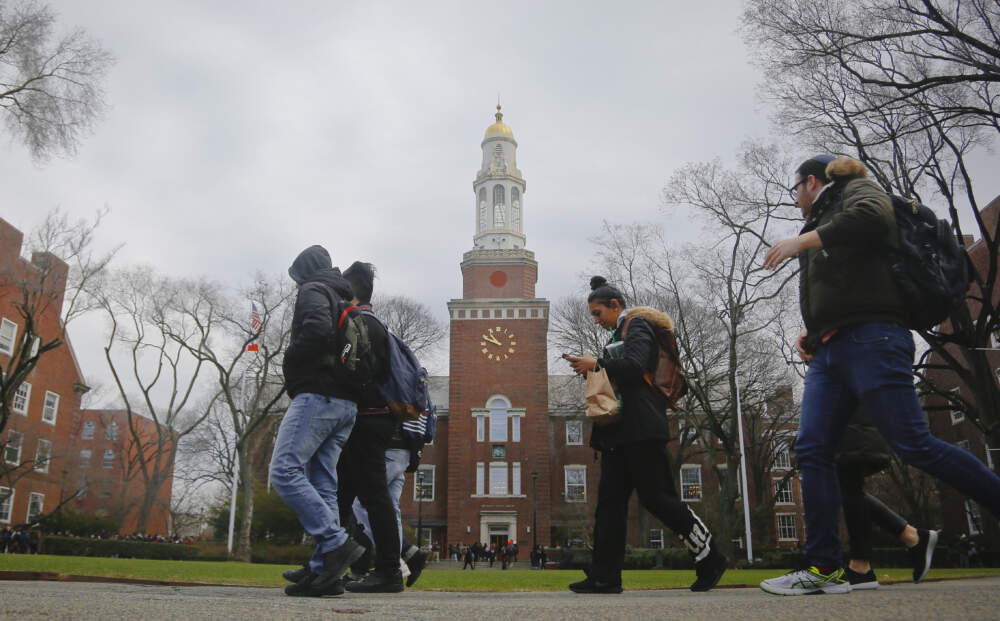 Brooklyn College students walk between classes on campus in New York. (Bebeto Matthews/AP)