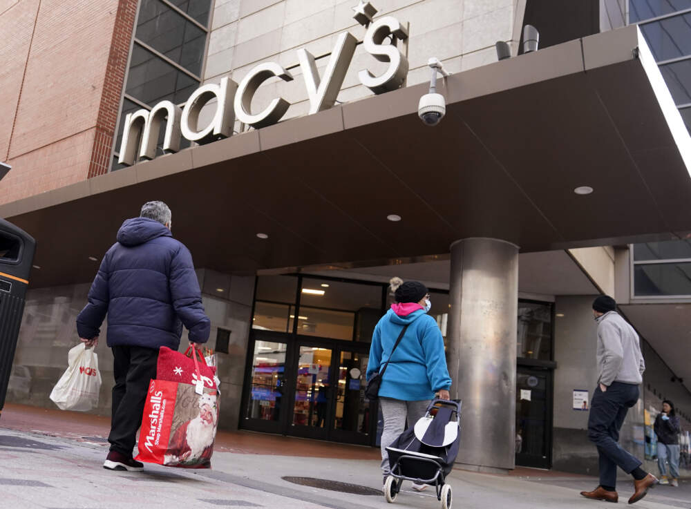 Shoppers walk to the Macy's store. (Charles Krupa/AP)