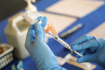 A nurse prepares a syringe of a COVID-19 vaccine. (Rogelio V. Solis/AP)
