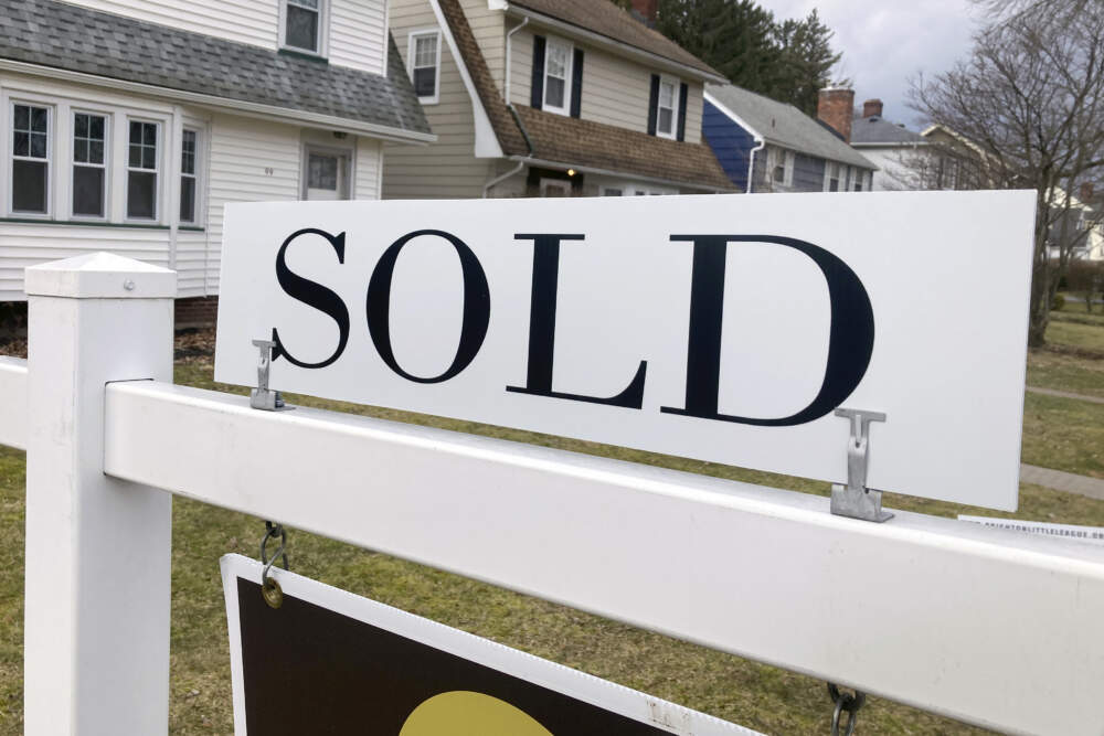 A sold sign hangs in front of a Brighton, New York house. (Ted Shaffrey/AP)