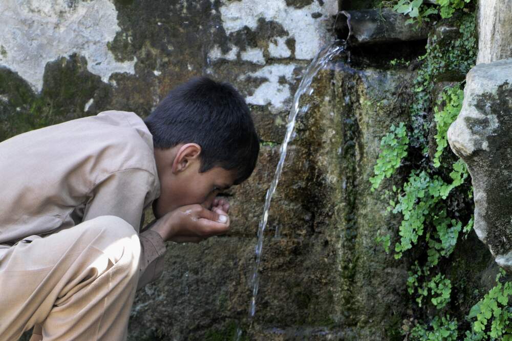 A boy drinks water from a line connected with a waterfall on the outskirts of Mingora, the main town of Pakistan's Swat valley The flooding in Pakistan killed at least 1,700 people, destroyed millions of homes, wiped out swathes of farmland, and caused billions of dollars in economic losses. In Khyber Pakhtunkhwa, residents had to rely on contaminated water, so now authorities are taking steps to prepare for the next disaster. (Naveed Ali/AP)