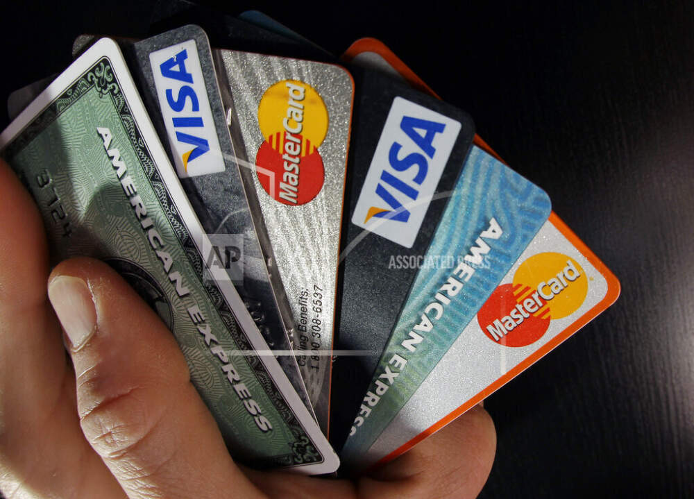 FILE - Consumer credit cards are posed in North Andover, Mass., March 5, 2012. The Consumer Financial Protection Bureau is considering a new rule that would slash credit card late fees by 75%, from current highs of up to $41 to as low as $8. (AP Photo/Elise Amendola, File)