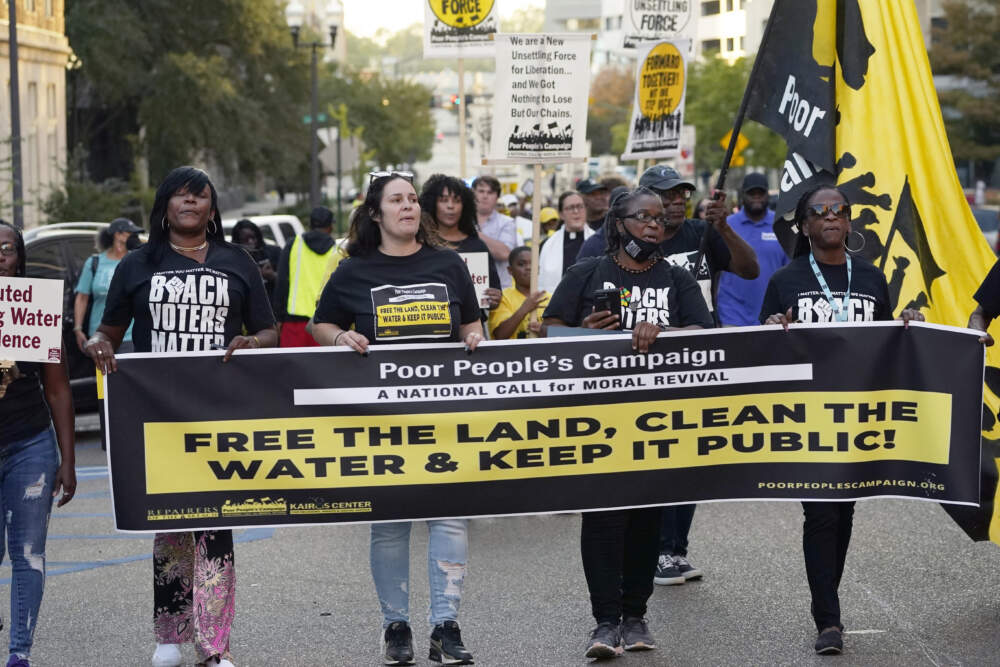 Jackson residents and supporters hold signs as they march to the Governor's Mansion to protest the ongoing water issues, poverty and other social ills. (Rogelio V. Solis/AP)
