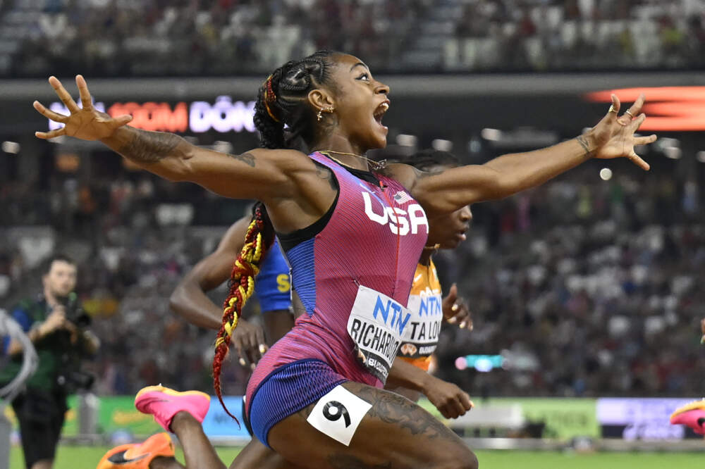 Sha'Carri Richardson, of the United States, spreads her arms as he crosses the line to win gold in the women's 100-meter final during the World Athletics Championships in Budapest, Hungary. (Denes Erdos/AP)