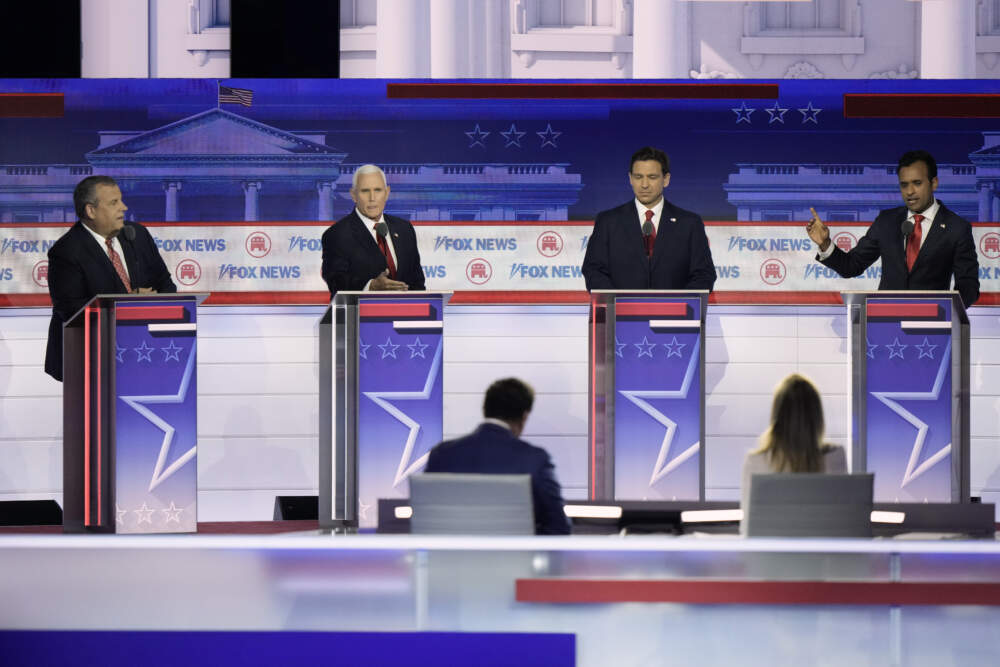 Former Vice President Mike Pence and businessman Vivek Ramaswamy talk as former New Jersey Gov. Chris Christie and Florida Gov. Ron DeSantis listen during a Republican presidential primary debate hosted by FOX News Channel. (Morry Gash/AP)
