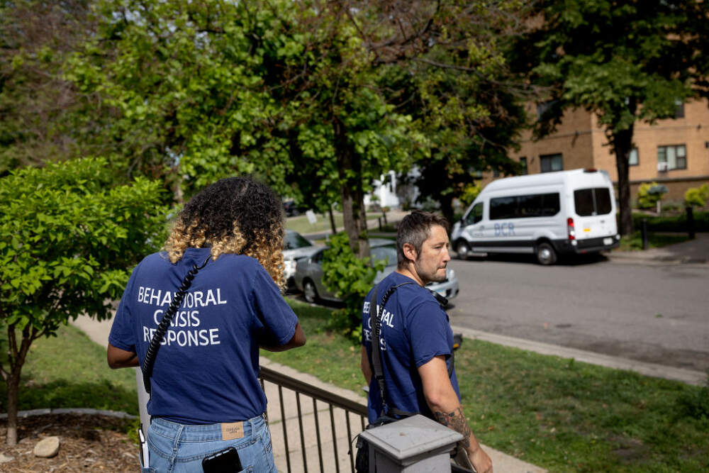 Shamso Iman, left, and Dane Haverly, with the Behavioral Crisis Response team, leave the scene after responding to a distress call in Minneapolis, Minn., on Tuesday, July 11, 2023.  (Elizabeth Flores/Star Tribune via Getty Images)