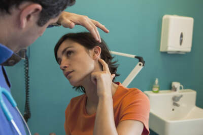 A doctor checks a patient's ear pain. (Getty Images)