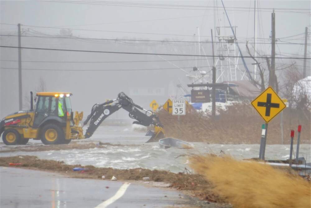 Coastal flooding closed several parts of Route 1A in Rye and North Hampton, New Hampshire on Friday, Dec. 23, 2022. Here, at Rye Harbor, a dingy floats up along the road. (Dan Tuohy/NHPR)