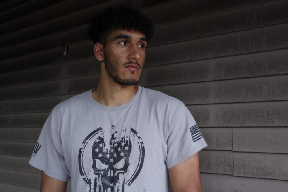 Omar Zai outside his Auburn apartment last week. Zai, who flew Black Hawk helicopters in an elite airborne unit of the Afghan armed forces, said he's been struggling to find a sense of direction in his life since he arrived in the U.S. in 2021. (Ari Snider/Maine Public)