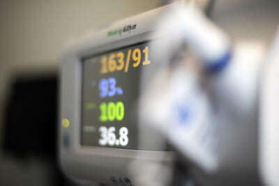 A patient's vital signs are displayed on a monitor at a hospital. (Jenny Kane/AP)