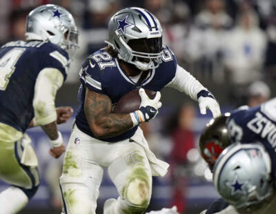 Dallas Cowboys running back Ezekiel Elliott (21) looks for running room as he rushes with the ball during an NFL wild-card football game against the Tampa Bay Buccaneers, Jan. 16, 2023. A person familiar with the terms tells The Associated Press that three-time Pro Bowl running back Elliott has signed a one-year deal with the New England Patriots worth $4 million. (Peter Joneleit/AP)