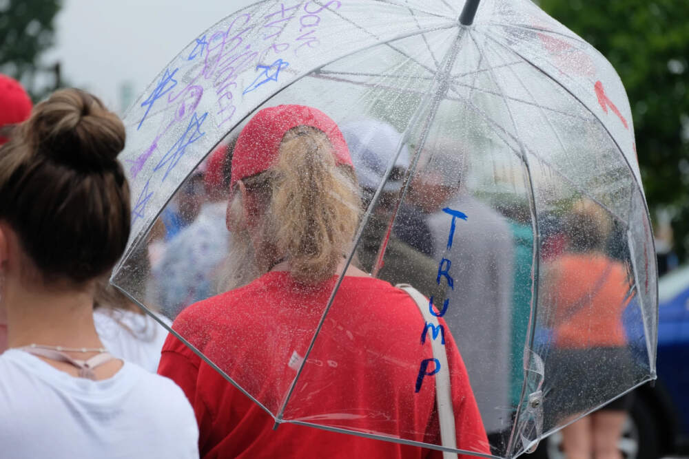 Despite intermittent downpours, supporters cued up for hours to attend Trump's rally at Windham High School. (Todd Bookman/NHPR)