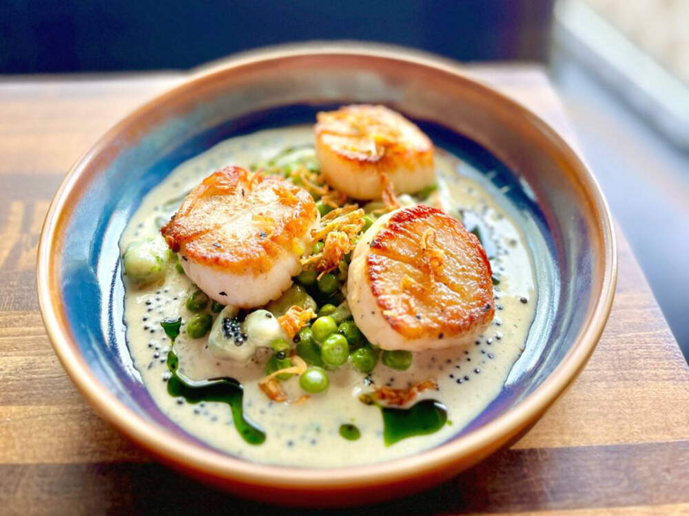 New Bedford diver scallops with English peas, potato dumplings, preserved lemon and beer cream. (Courtesy of Prairie Fire)