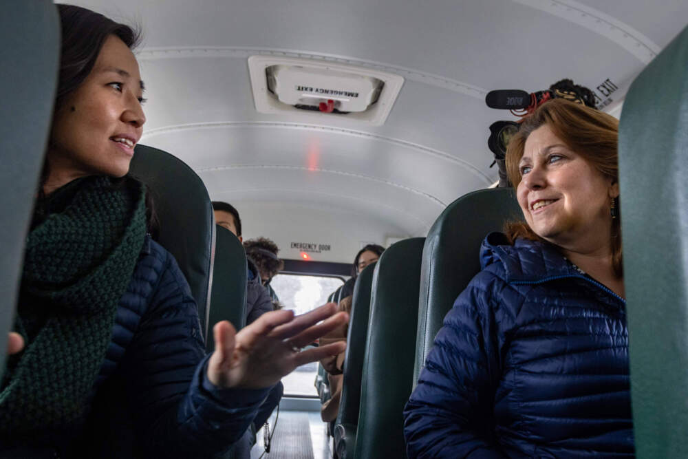 Boston Mayor Michelle Wu, and Superintendent of Boston Public Schools, Mary Skipper chat while riding a school bus. (Jesse Costa/WBUR)