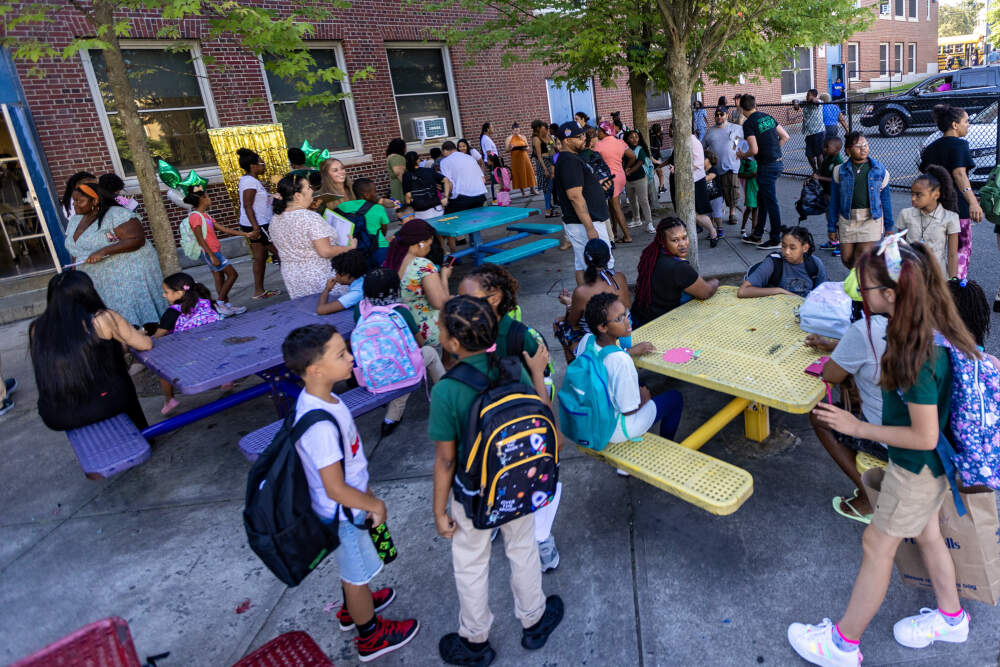 School faculty greets students and parent at the P.A. Shaw Elementary School in Dorchester on the first day of school in Boston. (Jesse Costa/WBUR)