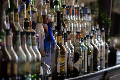 Bottle of liquor behind a bar in Jamaica Plain. (Jesse Costa/WBUR)