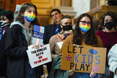 People gather to protest against HB1041, a bill to ban transgender women and girls from participating in school sports that match their gender identity, during a rally at the Statehouse in Indianapolis, Wednesday, Feb. 9, 2022. (Michael Conroy/AP)