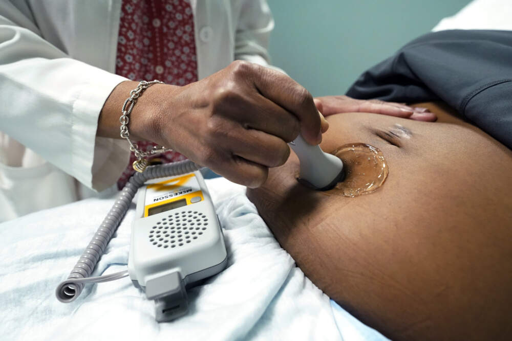 A midwife measures the heartbeat of a patient's fetus.  (Rogelio V. Solis/AP)