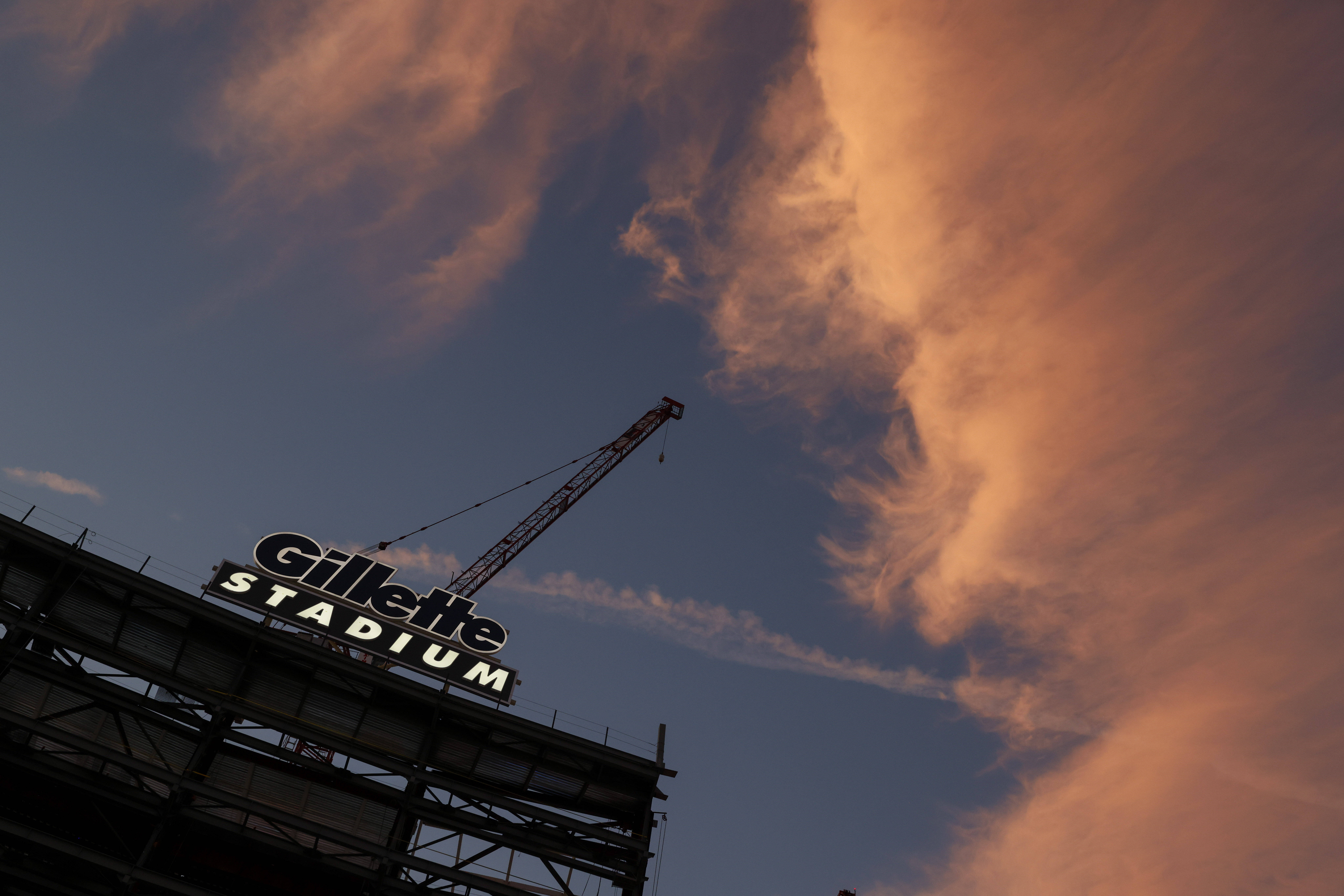A general view of the new construction taking place at Gillette Stadium with colorful clouds at sunset in 2022. (Greg M. Cooper/AP)