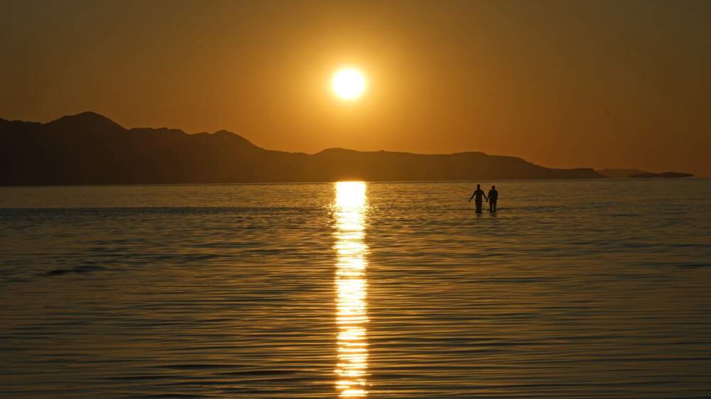 The sun sets on the Great Salt Lake on June 15, 2023, near Magna, Utah. A coalition of environmental organizations sued the state of Utah on Wednesday, Sept. 6, 2023, based on accusations that it is not doing enough make sure enough water gets to the shrinking Great Salt Lake. (Rick Bowmer/AP)