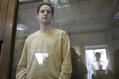 Wall Street Journal reporter Evan Gershkovich stands in a glass cage in a courtroom at the Moscow City Court. (Dmitry Serebryakov/AP)