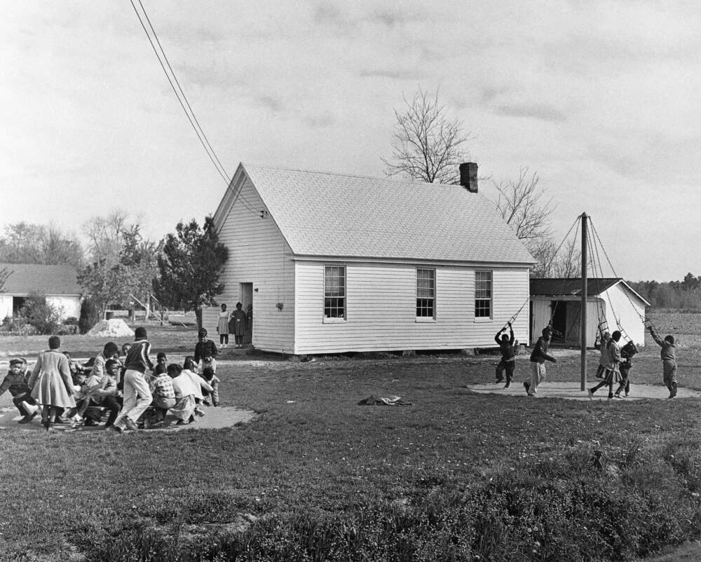Children play outside of the one-room schoolhouse in 1961. (AP Photo)