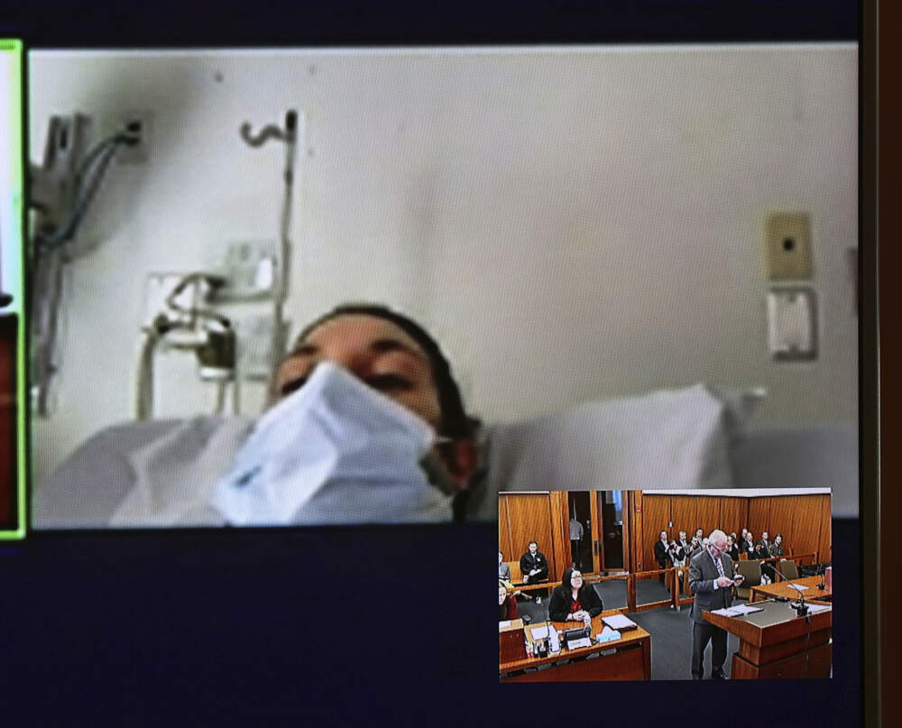In this video screen image, Lindsay Clancy with a surgical mask over her face in a hospital appears during her arraignment on charges regarding her three children's deaths at Plymouth District Court Tuesday, Feb. 7, 2023, in Plymouth, Mass. (David Ryan/The Boston Globe via AP, Pool, File)