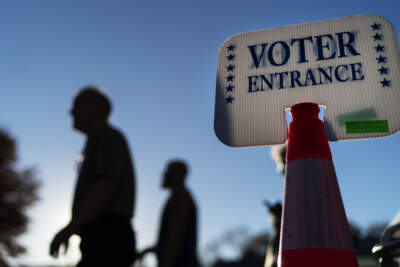 Voters pass a sign outside a polling site in Warwick, R.I., Monday, Nov. 7, 2022. (David Goldman/AP)