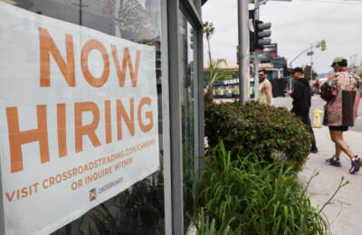 A 'Now Hiring' sign is displayed outside a resale clothing shop on June 2, 2023 in Los Angeles, California. Today’s U.S. labor report shows that employers added 339,000 jobs in May with sectors including construction, healthcare, business services and transportation adding jobs with wages showing 4.3 percent growth over the same period last year. (Mario Tama/Getty Images)