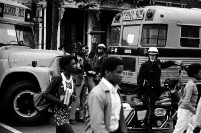 Bused black schoolchildren arrive with police escort at South Boston High School during court-ordered desegregation crisis, South Boston, Massachusetts, 1974. (Spencer Grant/Getty Images)