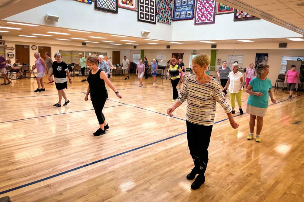 On Wednesday mornings, the big room at the St. George Active Life Center fills with line dancers. Ramona Wente, foreground, described the class as the best part of her week. (David Condos/KUER)