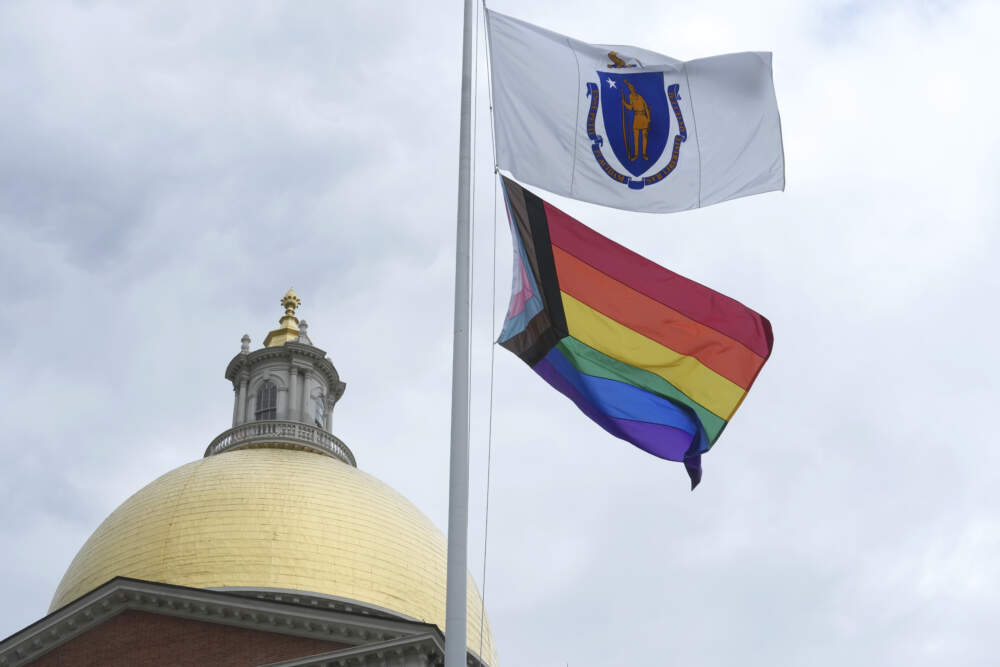 A Pride flag flies below a Massachusetts state flag in front of the Statehouse following a Pride Month Celebration, Wednesday, June 7, 2023, in Boston. (Steven Senne/AP)