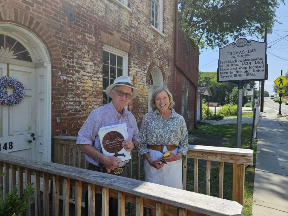 Volunteer docent Joe Graves and Milton Mayor Patricia Williams stand in front of the Thomas Day House, which will soon become the newest state historic site in North Carolina. (Colin Campbell/WUNC)