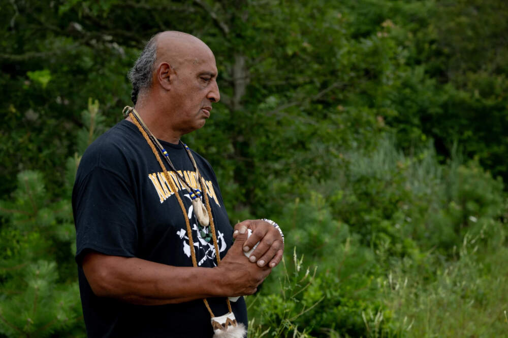 Mashpee Wampanoag Tribe member Vernon “Buddy” Pocknett looks out while standing along the edge of Santuit Pond on July 22, 2023, in Mashpee, Mass.