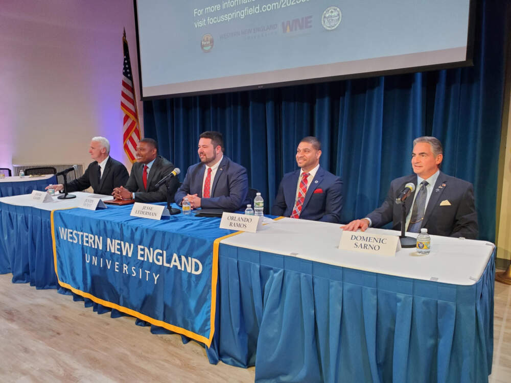 From left, Springfield mayoral candidates David Ciampi, Justin Hurst, Jesse Lederman, state Rep. Orlando Ramos, D-Springfield; and current mayor Domenic J. Sarno. A mayoral forum run by Focus Springfield was held at Western New England University on Thursday, Aug. 24, 2023. (Elizabeth Román/NEPM)