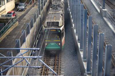 A train rides on the tracks in Somerville during testing runs of the Green Line Extension. (Jesse Costa/WBUR)