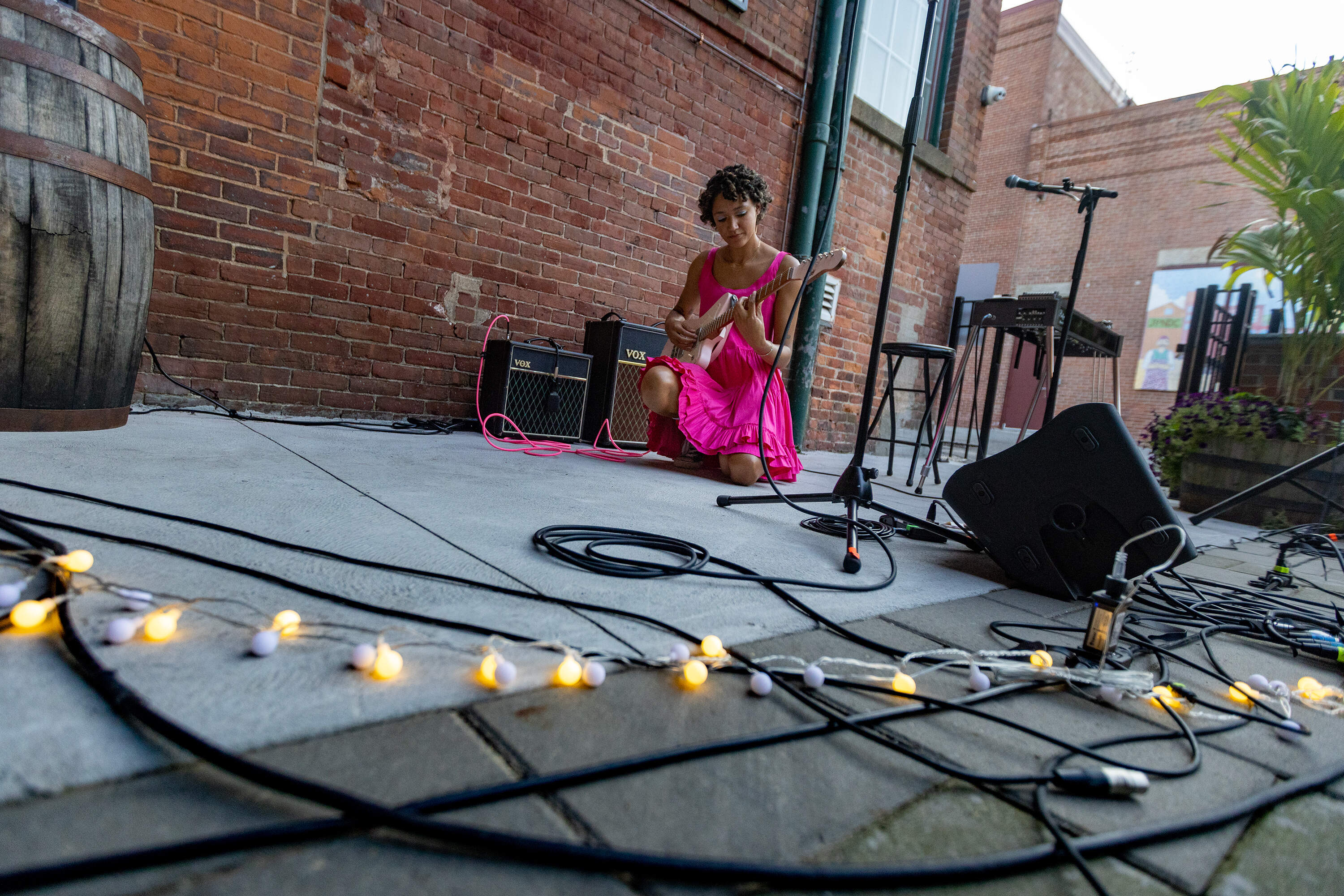 Kimaya Diggs tunes her guitar before going on stage at a Sofar Sounds night at Sam Adams Brewery in Jamaica Plain. (Jesse Costa/WBUR)