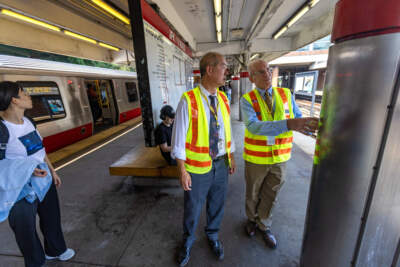 General Manager and CEO Phil Eng and the MBTA’s newly hired Chief of Stations Dennis Varley examine a column during a visit to JFK/UMASS station in Dorchester. (Jesse Costa/WBUR)