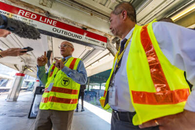 The MBTA’s newly hired chief of stations, Dennis Varley, speaks to reporters as General Manager Philip Eng listens during a visit to JFK/UMass station in Dorchester. (Jesse Costa/WBUR)