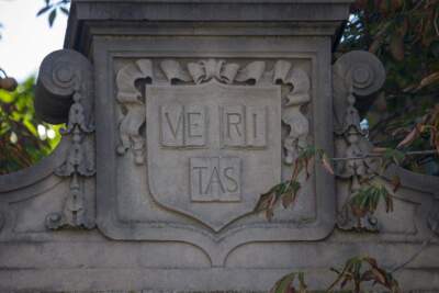 The Harvard Veritas coat of arms on one of the gates at Harvard Yars. (Jesse Costa/WBUR)