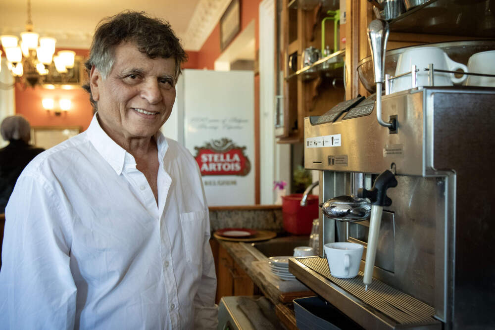 Andala Coffee House owner Sami Herbawi, by the coffee machine at the cafe in Cambridge. (Robin Lubbock/WBUR)