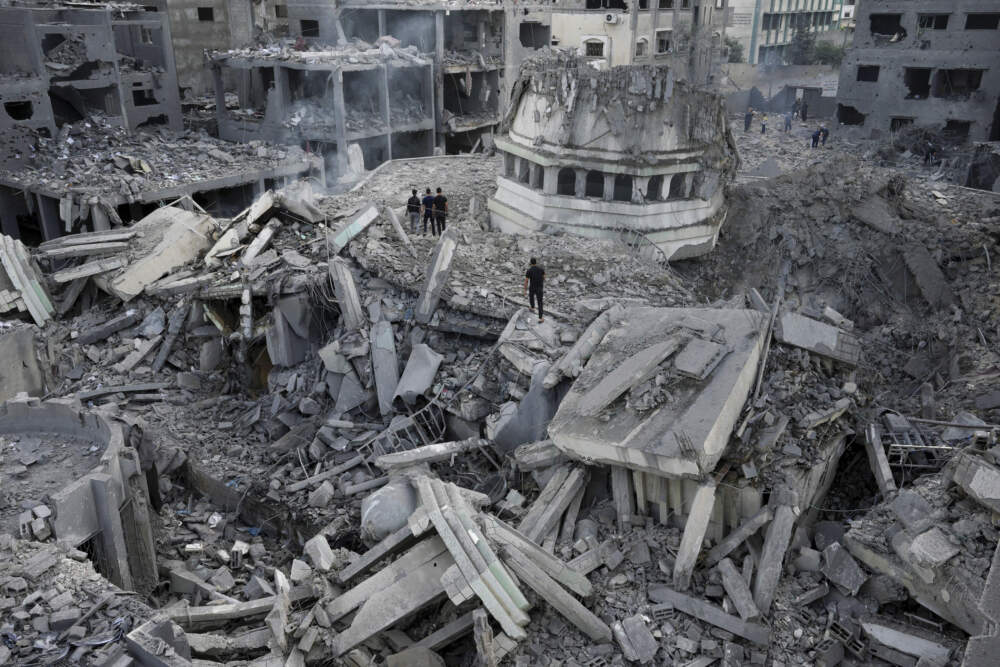Palestinians inspect the rubble of the Yassin Mosque destroyed after it was hit by an Israeli airstrike at Shati refugee camp in Gaza City, early Monday, Oct. 9, 2023. Israel's military battled to drive Hamas fighters out of southern towns and seal its borders Monday as it pounded the Gaza Strip. (Adel Hana/AP)