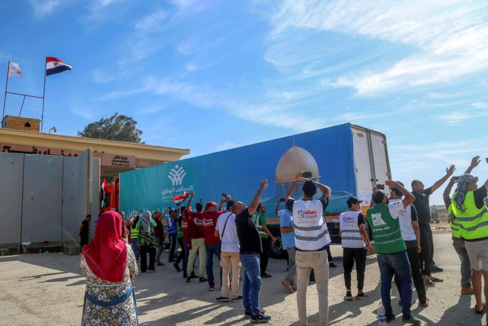 A truck of the Egyptian National Alliance carrying humanitarian aid for the Gaza Strip cross the Rafah border gate, in Rafah, Egypt, Saturday, Oct. 21, 2023. (AP Photo/Mohammed Asad)